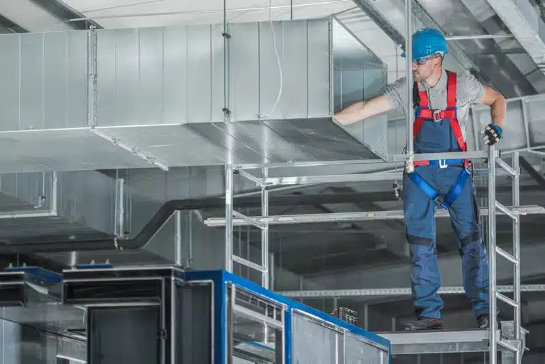 HVAC Technician installing a commercial air filter system